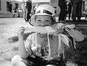 Kid eating corn