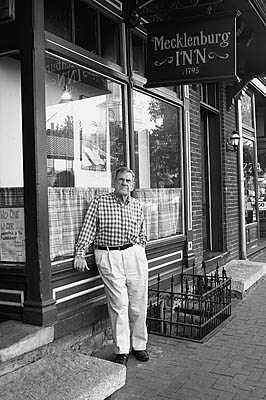 Clarence Wright leaning in front of inn