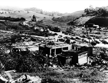 People gathering in a devastated neighborhood