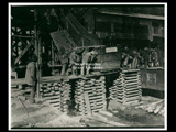 Lump of coal on trestle at mine Number 251, with men at work. This picture is also found in the DeHaven Collection, Roll 1601 09.