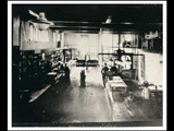 Interior of the store at Caretta. Several men are in the store.