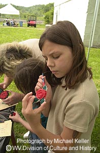 Girl painting ceramic rose